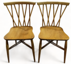 A pair of Ercol beech and elm side chairs - with lattice backs above contoured seats and twin X form