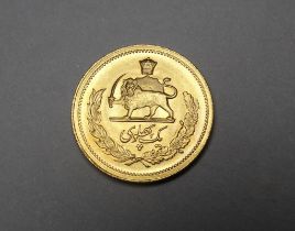 A one Pahlavi 22ct gold coin - obverse with bust of Mohammed Reza, the reverse with a lion holding a