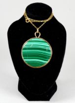A malachite pendent within a 9ct gold frame - circular, on a fine link chain