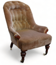 A Victorian walnut button upholstered low seat chair - the spoon shape back raised on turned