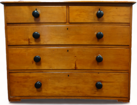 A late Victorian pine chest of drawers - the rectangular top above an arrangement of two short and