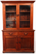 A Victorian pine dresser - the upper section with a moulded cornice and glazed panel doors