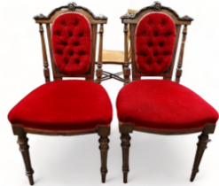 A pair of early 20th century walnut chairs - the carved top rail flanked by turned supports and