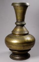 An early 20th century Indian brass vase - engraved with bands of flowers and foliage, height 29cm.