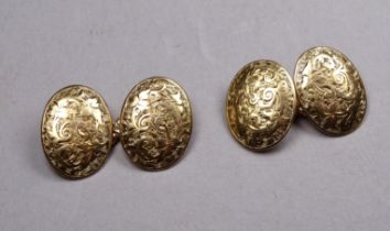 A pair of 18ct gold cufflinks - with oval buttons engraved with foliage, joined by chain links, 7g