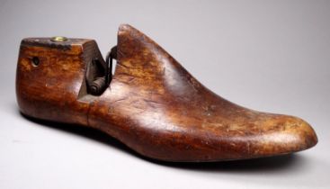 A beech shoe last - hinged towards the heel and with a steel base, size 9.5, length 30cm.
