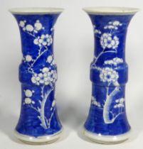 A pair of early 20th century Chinese Gu vases - with blue and white prunus pattern decoration and