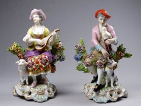 A late 19th/early 20th century continental porcelain figure of a seated piper with hound, height