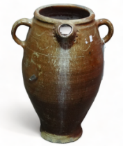 A late 19th century salt glazed water vessel - with twin handles and sgraffito decoration to the