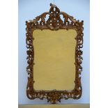 A gilt Louis XV style mirror in sculpted wood (138x74cm) (*)