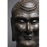 A CHINESE CARVED STONE HEAD OF LUOHAN. Dark heavy grey stone with well carved features, deep lines
