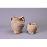 TWO CHINESE NEOLITHIC POTTERY JARS. To include a Siwa pottery jar with saddle like rim and two