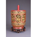 A LARGE CHINESE RED AND GILT WOOD BOX, 19TH CENTURY. Of cylindrical form on a ruyi base, well carved