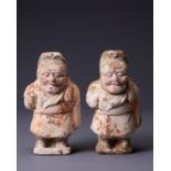 TWO CHINESE SMALL PAINTED POTTERY FIGURES OF ATTENDANTS, TANG DYNASTY (AD 618-907). Each modelled as