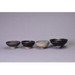 FOUR SONG DYNASTY (960-1279) BLACK GLAZED TEA BOWLS. In sizes, one with silvered streaks on a deep