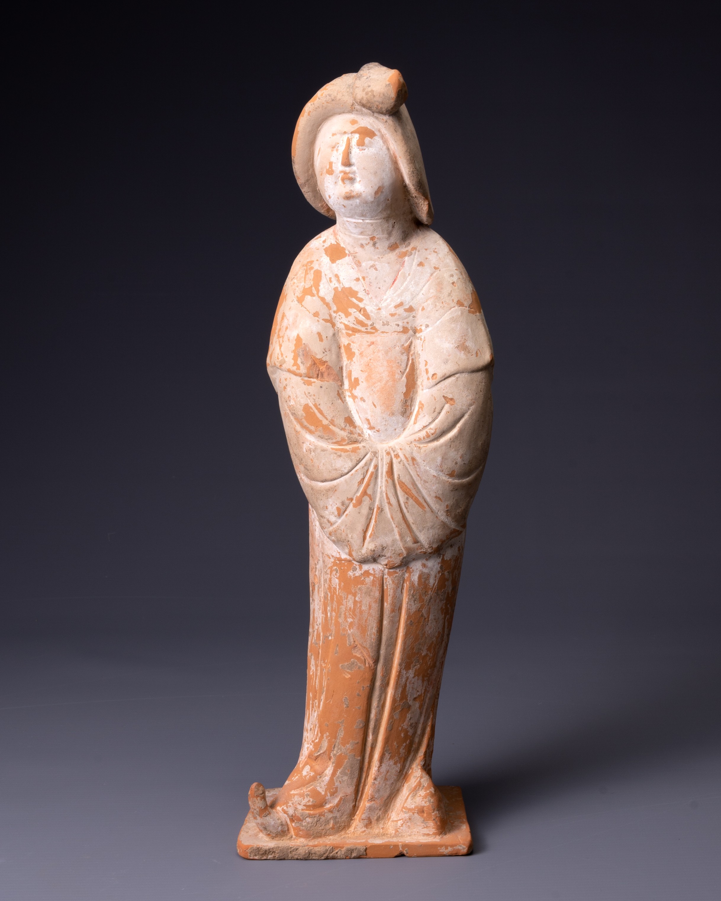 A CHINESE POTTERY FIGURE OF A COURT LADY, TANG DYNASTY (AD 618-907). Modelled wearing long flowing