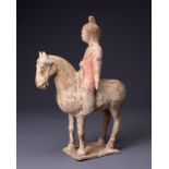 A CHINESE PAINTED POTTERY HORSE AND FEMALE RIDER, TANG DYNASTY (AD 618-907). The horse standing