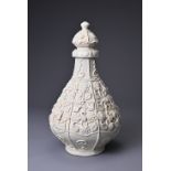 A CHINESE QINGBAI MOULDED PORCELAIN VASE AND COVER. Heavily potted pear shaped body with applied