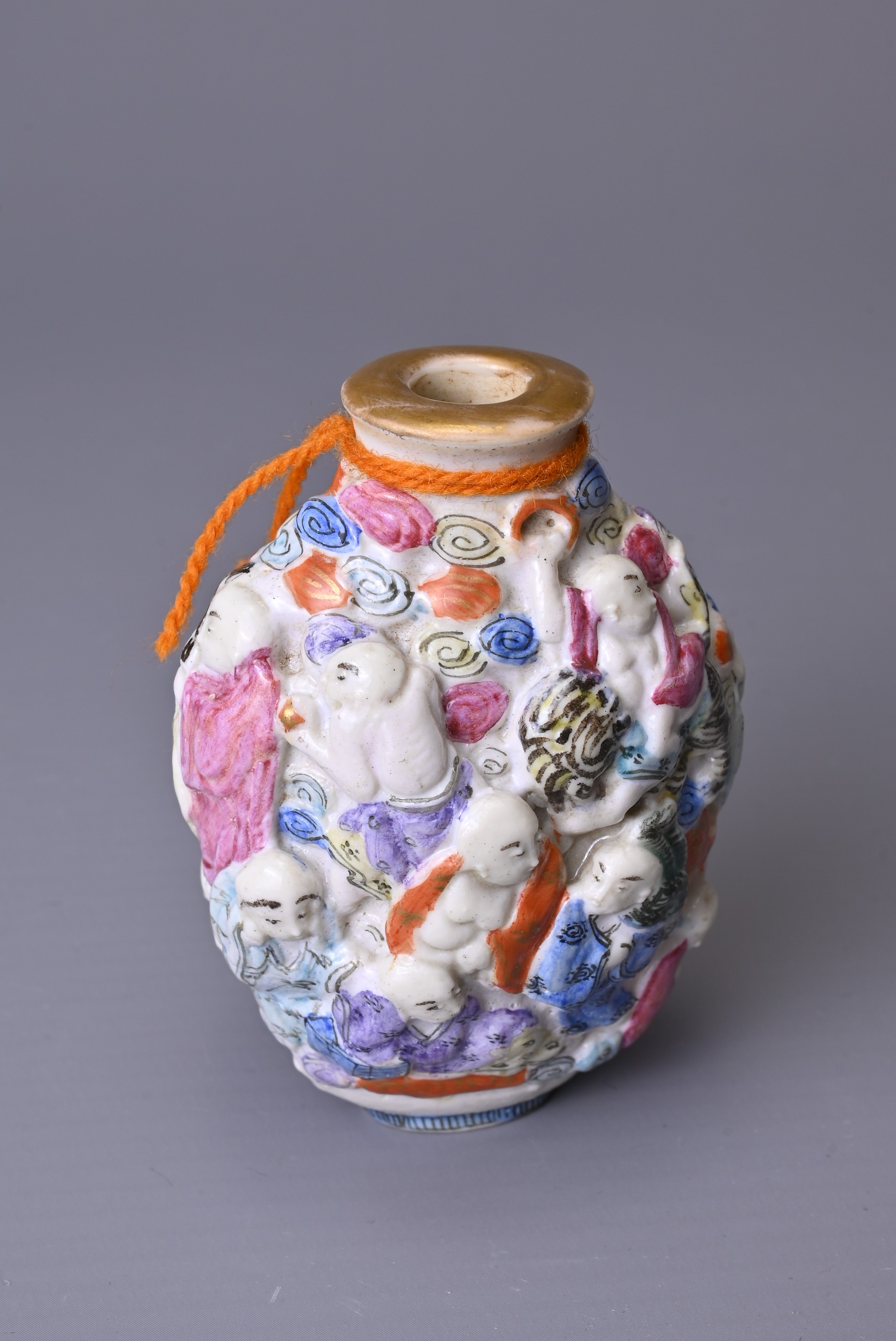A CHINESE FAMILLE ROSE PORCELAIN SNUFF BOTTLE, 19TH CENTURY. Moulded with the Eighteen Luohan - Image 7 of 7
