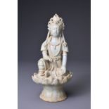 A CHINESE QINGBAI WARE FIGURE OF GUANYIN. The fairly heavily potted figure seated on a lotus base