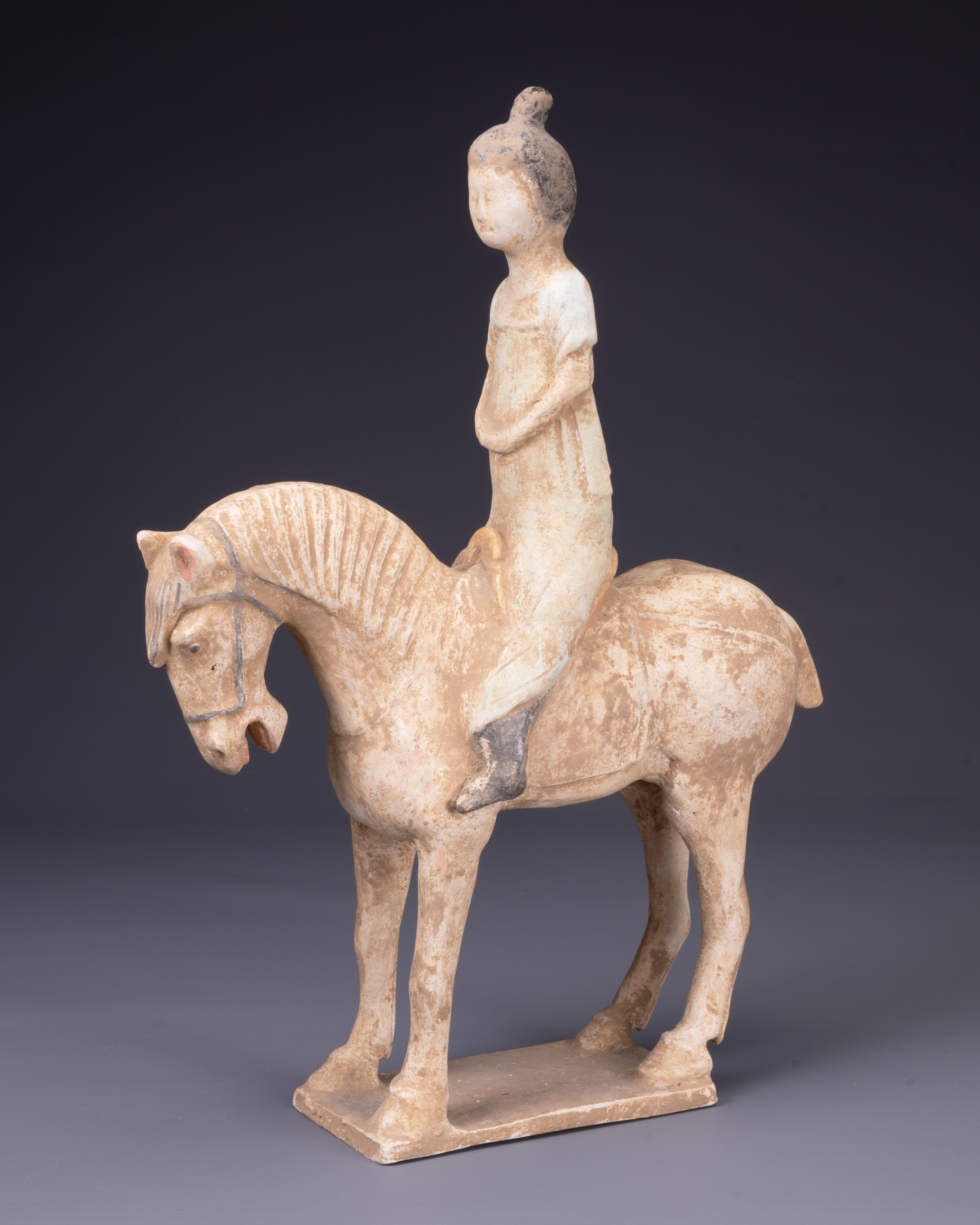 A CHINESE PAINTED POTTERY HORSE AND FEMALE RIDER, TANG DYNASTY (AD 618- 907). The horse standing