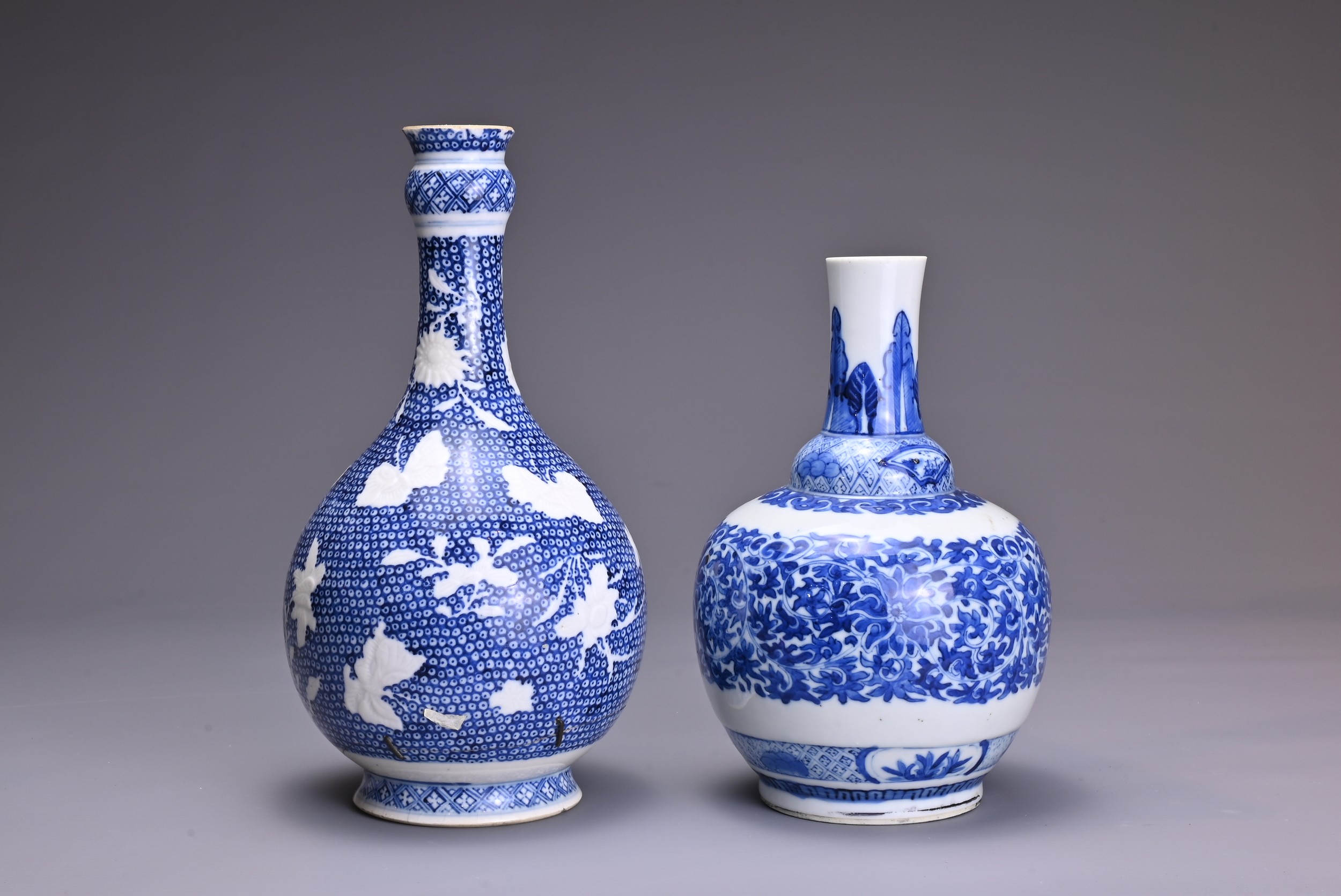 TWO CHINESE BLUE AND WHITE PORCELAIN VASES, 18/19TH CENTURY. An 18th century garlic-head bottle vase