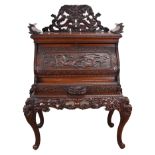 HEAVILY CARVED JAPANESE CHERRYWOOD SECRETAIRE, in two sections, standing on cabriole legs with