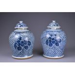 A PAIR OF CHINESE KANGXI (1662-1722) BLUE AND WHITE PORCELAIN BALUSTER VASES AND DOMED COVERS.