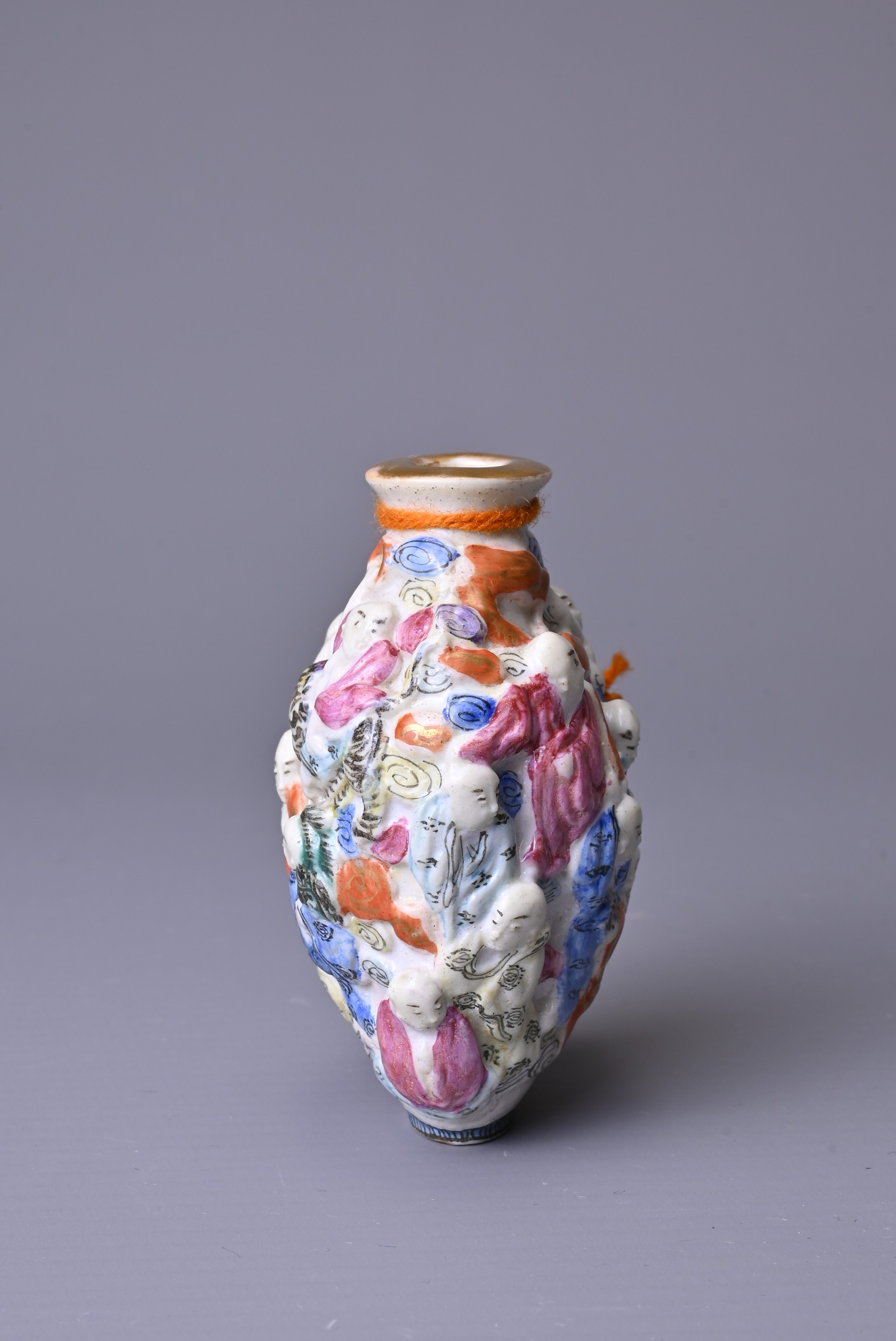 A CHINESE FAMILLE ROSE PORCELAIN SNUFF BOTTLE, 19TH CENTURY. Moulded with the Eighteen Luohan - Image 4 of 7
