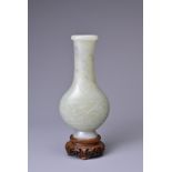 A CHINESE PALE CELADON JADE VASE, QIANLONG PERIOD (1735-96). Flattened ovoid body on a short tapered