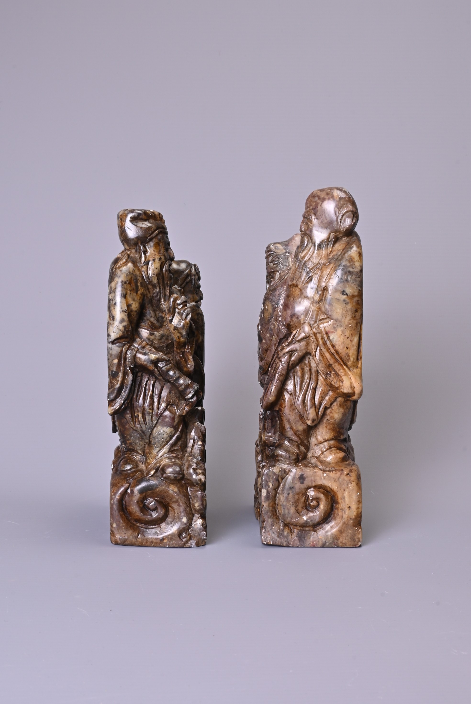 A PAIR OF 20TH CENTURY CARVED SOAPSTONE FIGURES OF A SAGE AND ATTENDANT. Each in mottled dark - Image 2 of 7