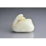 A CHINESE WHITE AND RUSSET JADE CARVING OF A CRANE, QING DYNASTY. Seated with its head turned to its