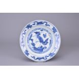 A CHINESE BLUE AND WHITE PORCELAIN PHOENIX DISH, MING DYNASTY. With central motif of a phoenix in