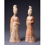 TWO CHINESE PAINTED POTTERY FIGURES OF COURT LADIES, TANG DYNASTY (AD 618-907). Each modelled