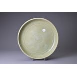 A CHINESE LONGQUAN CELADON DISH, YUAN / MING DYNASTY. Heavily potted with rounded sides decorated to