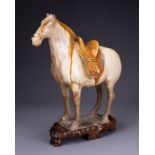 A CHINESE SANCAI GLAZED POTTERY MODEL OF A HORSE, TANG DYNASTY (AD 618-907). Modelled standing