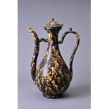 A CHINESE TORTOISE SHELL GLAZED POTTERY EWER AND COVER. The pear shaped body with long ribbed