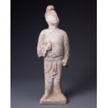 A CHINESE PAINTED POTTERY FIGURE OF AN ATTENDANT, TANG DYNASTY (AD 618-907). Modelled standing