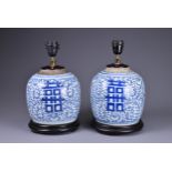 A PAIR OF 19TH CENTURY CHINESE PORCELAIN GINGER JARS MOUNTED AS LAMPS. Each decorated with scrolling