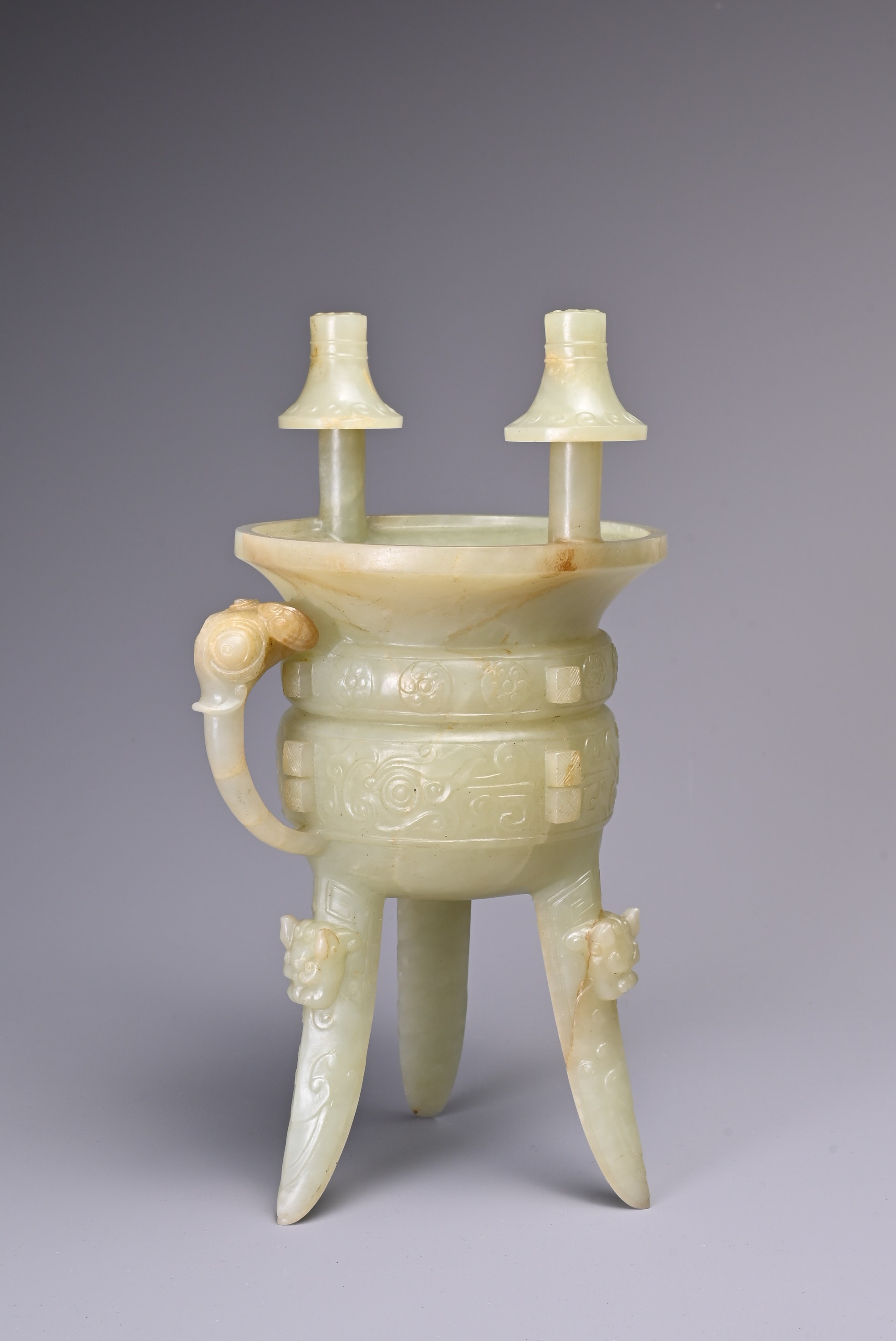 A CHINESE CELADON JADE TRIPOD VESSEL, JIA, QING DYNASTY. Modelled on the archaic bronze ceremonial