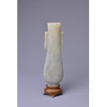 A CHINESE CELADON JADE TWIN HANDLED VASE, 18/19TH CENTURY. The flattened elongated pear shaped