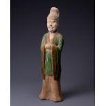 A CHINESE SANCAI GLAZED POTTERY FIGURE OF AN OFFICIAL, TANG DYNASTY (AD 618-907). Modelled