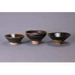 THREE CHINESE SONG DYNASTY (960-1279) BLACK GLAZED TEA BOWLS. In sizes, a conical example with