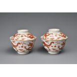 A PAIR OF CHINESE IRON RED DECORATED DRAGON CUPS AND COVERS, SHENDE TANG ZHI MARK. Finely potted,