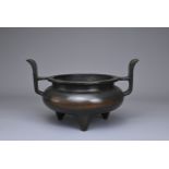 A CHINESE BRONZE TRIPOD CENSER, YU TANG QING WAN MARK. Circular form on three coned feet with raised