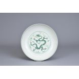 A CHINESE PORCELAIN DRAGON DISH, EARLY 20TH CENTURY. Decorated in green enamel with a dragon chasing