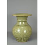 A CHINESE LONGQUAN CELADON VASE. Heavily potted of baluster form with moulded panels of fruits and