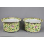 A LARGE PAIR OF CHINESE LIME GREEN GROUND FAMILLE ROSE PORCELAIN JARDINIERES. Of cylindrical form