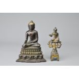 TWO CHINESE / BURMESE BRONZE DEITY FIGURES. To include a seated figure of Buddha on a lotus pedestal
