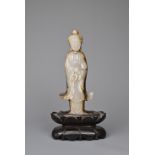 A CHINESE AGATE CARVING OF A STANDING BUDDHA, QING DYNASTY. The figure standing in flowing robes